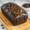 Freshly baked Chocolate Brownie Bread sliced on a wooden board, showcasing a rich, fudgy Brownie Loaf Cake texture with a glossy drizzle of hot fudge—perfect for fans of Different Types Of Brownies, Giant Brownies, and easy Chocolate Quick Bread Recipes.