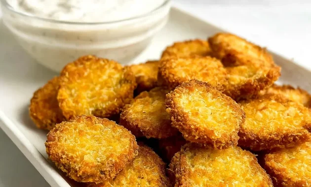 Golden brown Air Fryer Pickles served on a white plate with creamy ranch dip – the perfect Crispy Fried Pickles Snack for parties or easy weeknight munchies.