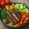 A vibrant Greek Steak Bowl featuring sliced sirloin, fresh cherry tomatoes, cucumber, olives, feta, and creamy tzatziki on a bed of grains—perfect Easy Healthy Weekday Dinners, Fast Mediterranean Recipes, and Healthy Dinner Recipes For Family Mediterranean.