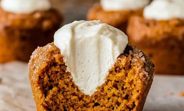Close-up of moist Pumpkin Muffins With Maple Cream Cheese, topped with cinnamon sugar and filled with creamy maple cream cheese—perfect Thanksgiving Dishes Dessert idea. These bakery-style Pumpkin Cream Cheese Desserts look like Pumpkin Cream Cheese Crumble Muffins with a touch of sparkle, giving the cozy feel of Pumpkin Spice Muffins With Whipped Cream. Beautifully golden Pumpkin Muffins Filled With Cream Cheese and optional Nut-topped Pumpkin Muffins, ideal for seasonal Fall Baking Recipes and festive Pumpkin Recipes Dessert creations.