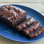 Slice of moist chocolate espresso banana bread with gooey chocolate chips, perfect for Chocolate Espresso fans and a standout Espresso Banana Bread in any Bread Recipes Sweet or Baking Sweets roundup; a decadent Dessert Bread moment for Banana Recipes lovers inspired by How Sweet Eats, ideal for Bread Recipes Homemade and when you just want to Eat Dessert.