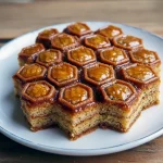 A golden Greek Honey Cake soaked in syrup, topped with crushed nuts — the ultimate Easy Honey Dessert with warm Unique Dessert Flavors that rivals Restaurant Dessert Recipes.