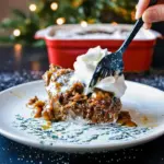 A warm slice of Gingerbread Pudding cake topped with melting vanilla ice cream, showing off its rich Gingerbread Cake With Sauce layer — the ultimate Ginger Cake Christmas dessert for cozy winter nights.