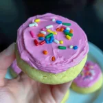 A batch of frosted Low Carb Cookies arranged on parchment paper — soft, fluffy, and beautifully topped with pink frosting, perfect for Keto Cookie Recipes or Keto Christmas Cookies.