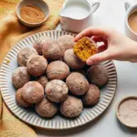 Close-up of warm, sugar-dusted Cinnamon Pumpkin Mini Muffins on a cooling rack, showing golden tops and a cinnamon-sugar sheen, Mini Cinnamon Sugar Pumpkin Muffins.