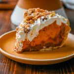 A stunning Milk Pumpkin Pie topped with whipped cream and golden streusel, inspired by the famous Pumpkin Pie Milk Bar, the ultimate Pumpkin Cream Dessert for Homemade Thanksgiving Pies.