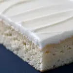 A moist almond sheet cake baked in a Sheet Cake Pan, topped with smooth almond glaze and sliced into perfect Dessert Bar pieces — a dreamy Almond Sheet Cake Recipe for lovers of Yummy Sweets and Decadent Cakes.