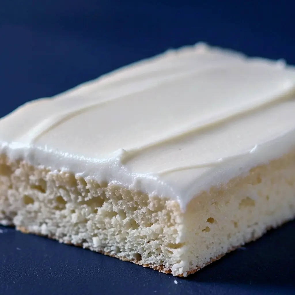 A moist almond sheet cake baked in a Sheet Cake Pan, topped with smooth almond glaze and sliced into perfect Dessert Bar pieces — a dreamy Almond Sheet Cake Recipe for lovers of Yummy Sweets and Decadent Cakes.