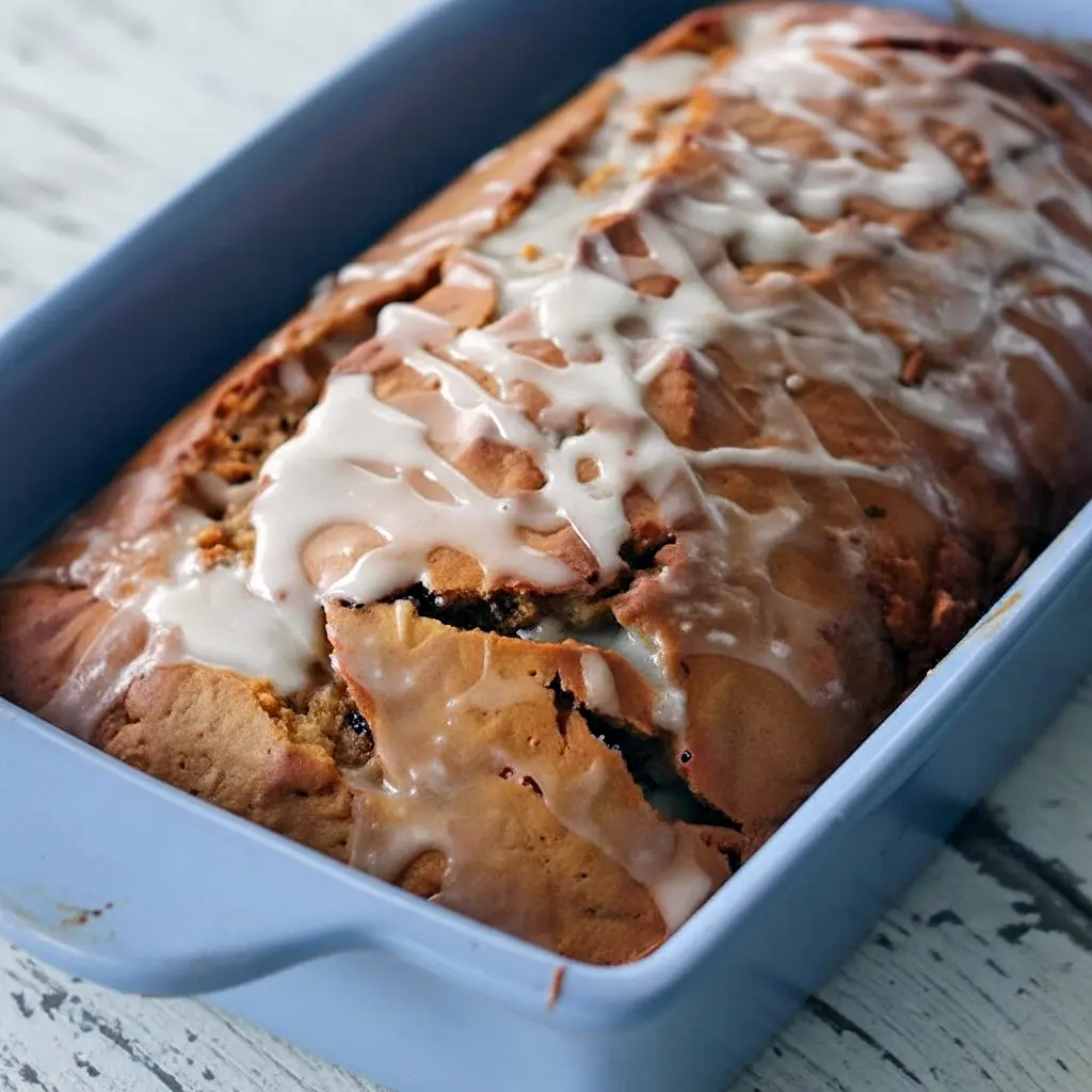 A moist Gingerbread Cake topped with glossy ginger icing, sliced and ready to serve — the Best Gingerbread Loaf Recipe for cozy mornings or a Cookie Exchange, inspired by a classic Gingerbread Coffee Cake Recipe Allrecipes style with hints of Spiced Gingerbread Loaf and Iced Gingerbread Loaf charm.