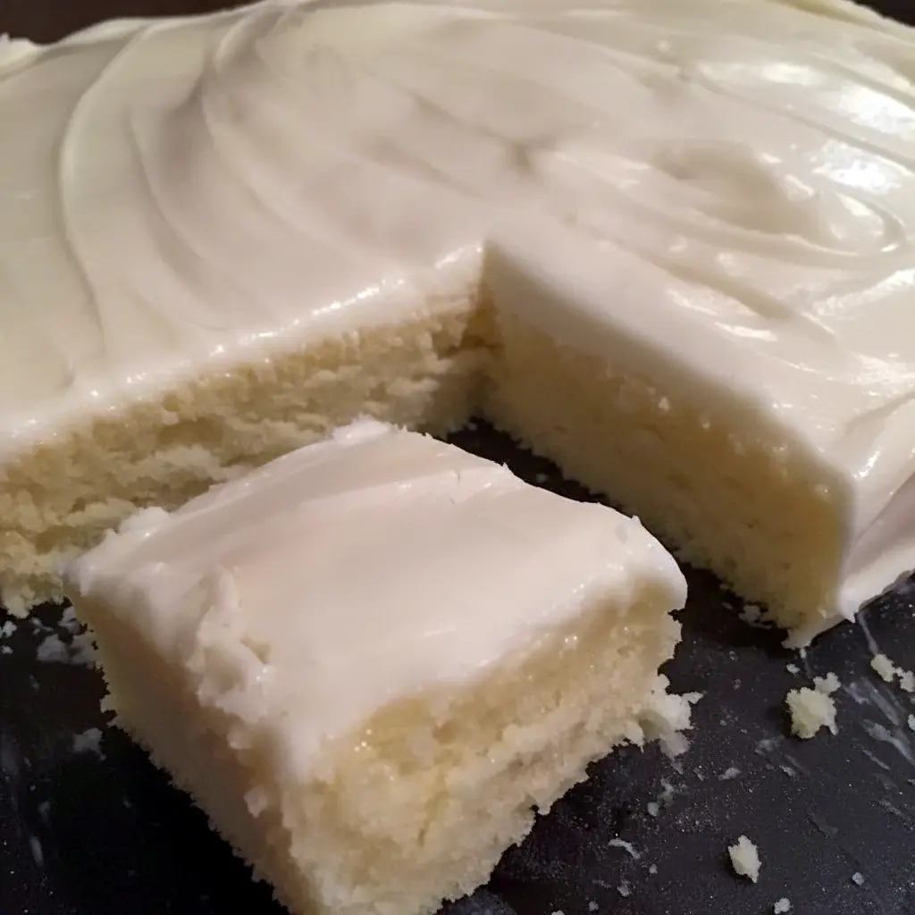 Almond Sheet Cake Recipe: Golden almond sheet cake in a greased Sheet Cake Pan, sliced like a Dessert Bar, topped with glaze, chopped nuts and mini Marshmallows, a tempting photo for fans of Sheet Cake Recipes, Almond Cakes, Food Cakes, Yummy Sweets and other Decadent Cakes.