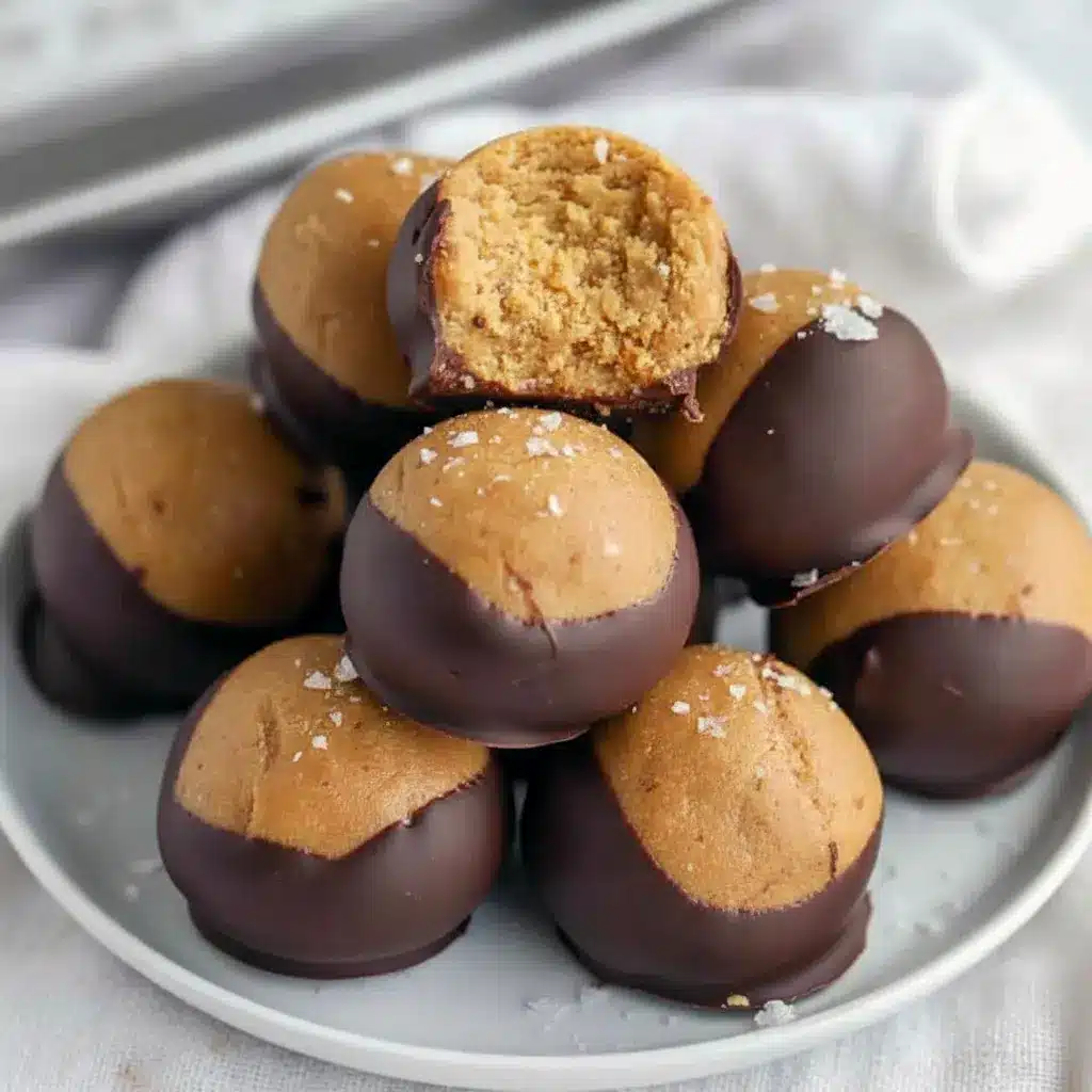 Close-up of chocolate-dipped Buckeyes Recipe balls made with creamy Healthy Peanut Butter, showing glossy chocolate coating and soft peanut butter center — the ultimate Healthy Chocolate Peanut Butter Treats for dessert or snack.