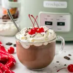 Hot Cocoa Drinks slow cooker mug of cherry chocolate topped with whipped cream and cherries — a Holiday Homemade Cocoa Drink that’s an easy pick for Hot Chocolate Flavor Ideas or a special Specialty Hot Chocolate treat.