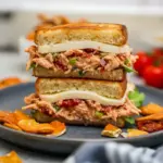 Close-up of a sun-dried tomato chicken salad on toasted sourdough with basil — a grab-and-go Fun Chicken Salad Recipes idea perfect for Pre Made Lunches, simple Lunch Chicken Meal Prep, loaded with Meals With Sundried Tomatoes, styled like a Gourmet Chicken Salad, great as Sides For Chicken Salad Sandwiches, turnable into a Loaded Chicken Salad, ideal for Sandwich Salad Recipes, and ultimately a classic Chicken Salad With Sundried Tomatoes.