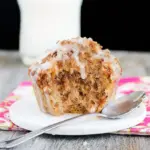 Single-serve mug cake with golden streusel topping, served warm in a white mug.