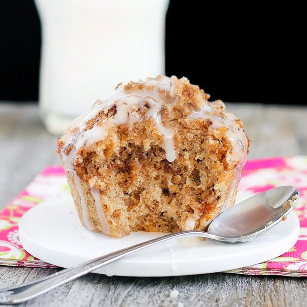 Single-serve mug cake with golden streusel topping, served warm in a white mug.