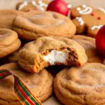 Close-up of a spiced gingerbread cookie stuffed with creamy cheesecake, rolled in cinnamon sugar and dusted with powdered sugar, Christmas Gingerbread Cheesecake Cookies.
