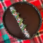 Christmas Chocolate Mousse Pie-style tart with dark glaze and peppermint-white mousse in a chocolate crust — a festive Peppermint Christmas Desserts centerpiece that also works for Thanksgiving Tarts Desserts or as a bold Christmas Pie Chocolate display, Christmas Showstopper Desserts.