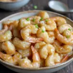 Close-up of golden, crispy Chinese Coconut Shrimp served on a plate with dipping sauce — a simple and delicious option for Shrimp Recipes For Dinner, inspired by a flavorful Chinese Coconut Shrimp Recipe and perfect for anyone who loves Coconut Shrimp Recipes, Seafood Dish Recipes, or easy Chinese Cooking Recipes. A tasty pick for Shrimp Recipes Easy, crowd-pleasing Shrimp Dishes, and a quick, satisfying Seafood Dinner.