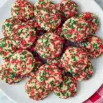 Stack of colorful sprinkle pudding cookies on a cooling rack, perfect for Kindergarten Christmas Party Snacks, one of the Best Christmas Cookies Easy, and a fun companion to Savory Christmas Treats Party Appetizers, Soft Christmas Treats.