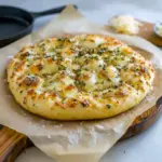 Close-up of golden garlic-Parmesan focaccia dotted with rosemary and flaky salt — showcases Foccacia Bread Flavors, quick Recipes With Foccacia Bread, and ideas for Different Types Of Foccacia Bread, Focaccia Bread Flavors.