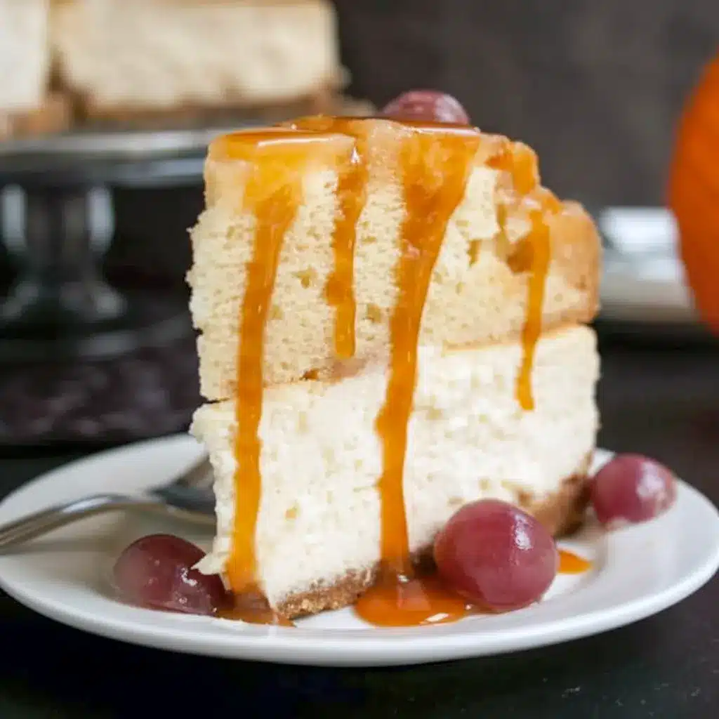 A slice of Pineapple Upside Down Cheesecake Cake with caramelized pineapple rings, cherries, and a creamy cheesecake layer on a white plate.