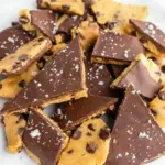 Close-up of Gluten Free Cookie Dough Bark pieces with glossy chocolate and flaky salt — a chewy, crunchy Non-dairy Cookie Dough Dessert that’s also a Dairy Free Sugar Free Dessert and fits Healthy Desserts Low Carb snack goals, Easy Gluten Free Vegan Dessert.