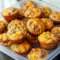 Easy Prep Breakfast — golden mini muffins studded with browned sausage and melted cheese on a wire rack, ready for grab-and-go mornings.