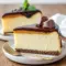 A slice of Millionaires Cheesecake showing a Buttery Biscuits-like crust, silky Creamy Cheesecake center, and warm Caramel Sauce dripping over the edge.