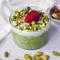 Jar of Raspberry Pistachio Overnight Oats layered with dairy-free yogurt, fresh raspberries, and chopped pistachios — a portable Overnight Oats Plant Based breakfast.