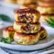 Easy Breakfast With Sausage — golden Sausage Pancake Muffins in a muffin tin, studded with browned sausage pieces and ready to pop into a lunchbox.