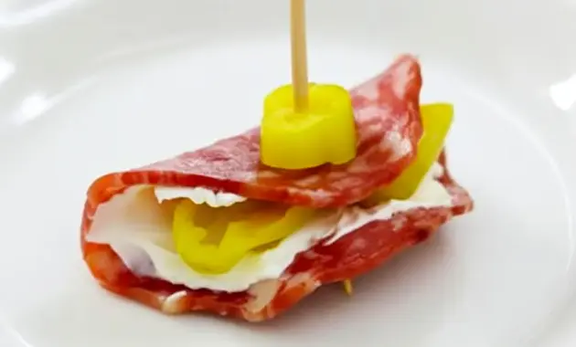 Platter of Salami Cream Cheese Pepperoncini Roll Ups arranged on a board, showing creamy centers and tangy pepperoncini — ideal Finger Food Appetizers for a crowd.