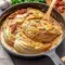 Skillet of golden, creamy Marry Me Melting Cabbage braised in a Tuscan-style sauce, garnished with parsley — a comforting Comfort Dishes and Cabbage Recipes plate ideal for Veggie Dishes.