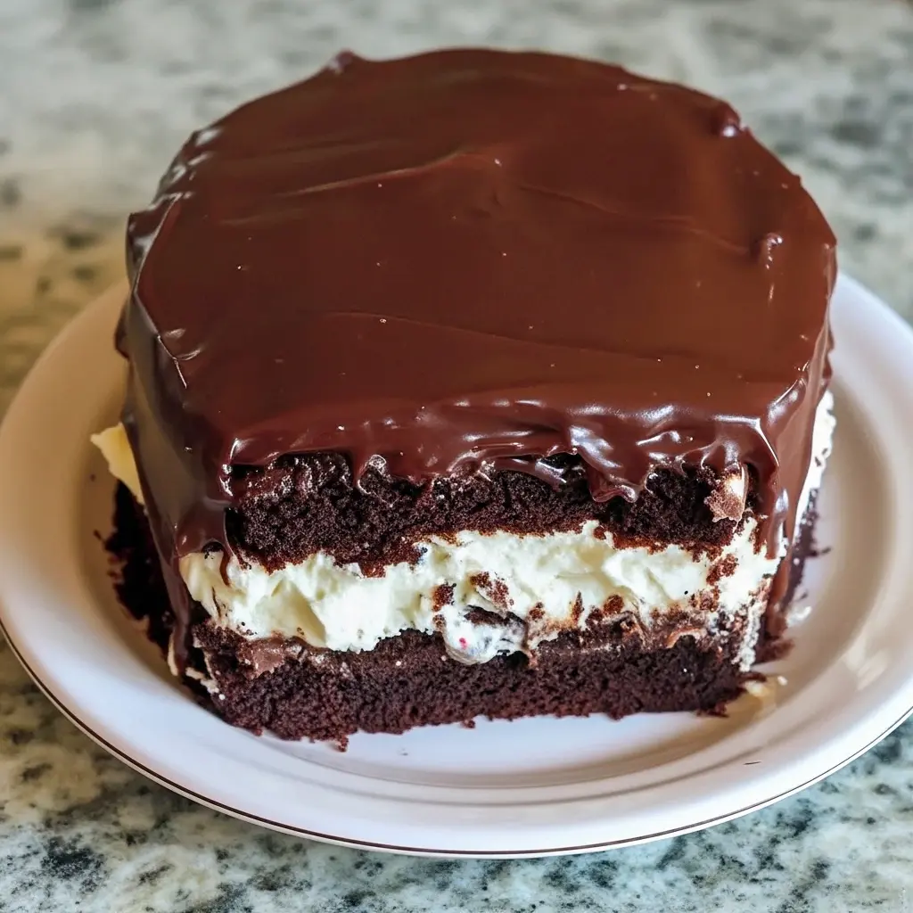 Sliced Ding Dong Cake showing moist chocolate layers and a fluffy cream filling — a classic Cakes With Filling look.