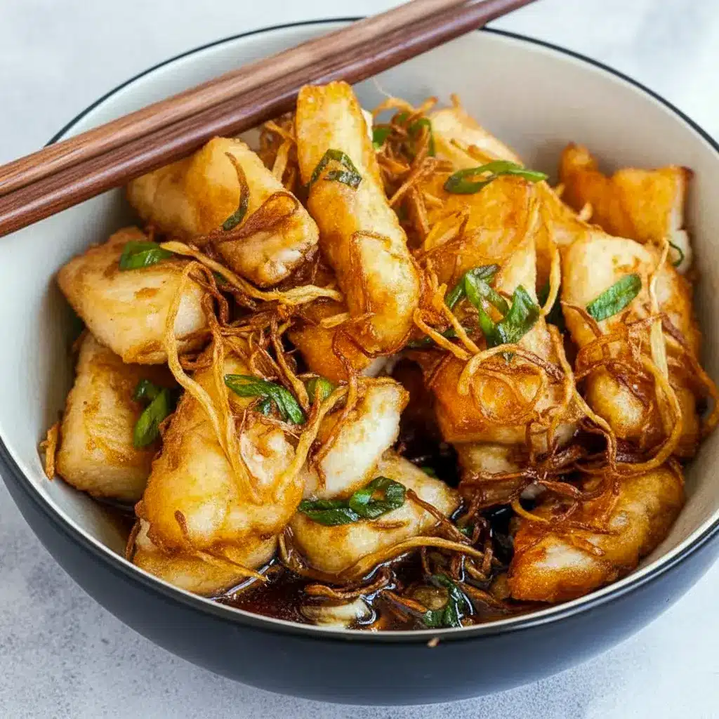 Close-up of golden pan-seared halibut glazed with soy-ginger sauce, topped with crispy ginger strips and scallions — an Asian Fish Dish Recipe and easy Asian Fish Dishes weeknight meal.