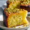 A slice of Lemon Pistachio Cake with lemon glaze and chopped pistachios — an easy Gluten Free Cake Almond Flour Recipe.