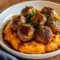 Pork Meatballs stacked on sweet potato mash, drizzled with bourbon-maple sauce and sprinkled parsley — a cozy Pork Meatball Dinner shot (close-up).