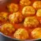 Bowl of Comfort Soups for Cold Weather — creamy tomato broth topped with golden Cheddar Bay dumplings and a sprinkle of parsley, a warm Tomato Dumpling Soup presentation.