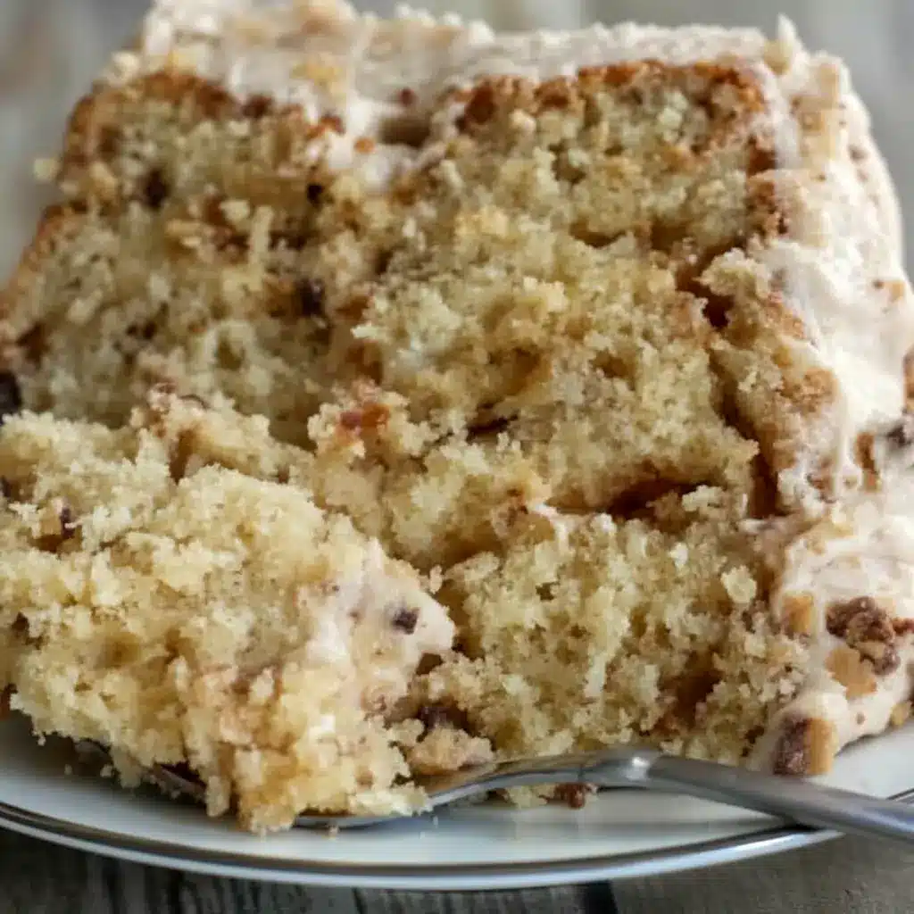 Banana Toffee Cake — slice showing banana-speckled crumb, glossy browned-butter toffee buttercream, and scattered toffee bits on top.