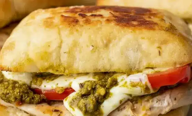 Chicken Pesto Sandwich on toasted ciabatta with juicy chicken, melted mozzarella, tomato slices, and pesto for a quick Healthy Chicken Sandwich Recipes style dinner.