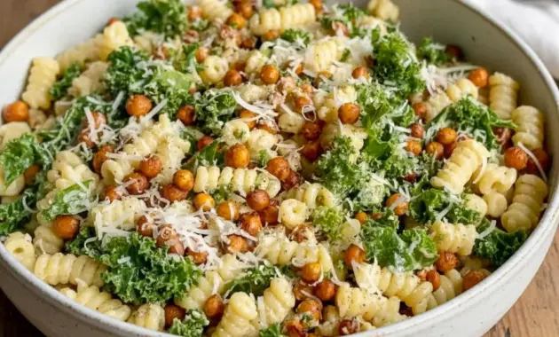 Bowl of Pasta Caesar Salad with shredded Kale, golden smoked chickpeas, and creamy tahini Caesar dressing — a fresh Good Eat ready to serve.