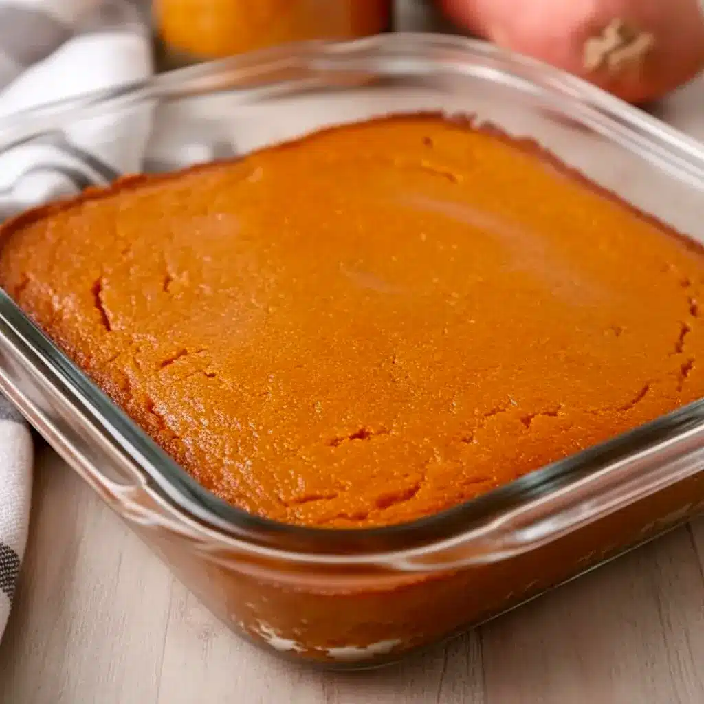 Slice of golden Sweet Potato Cornbread on a wooden board, glazed and ready — a top Quick Potato Side Dishes pick for cozy dinners.