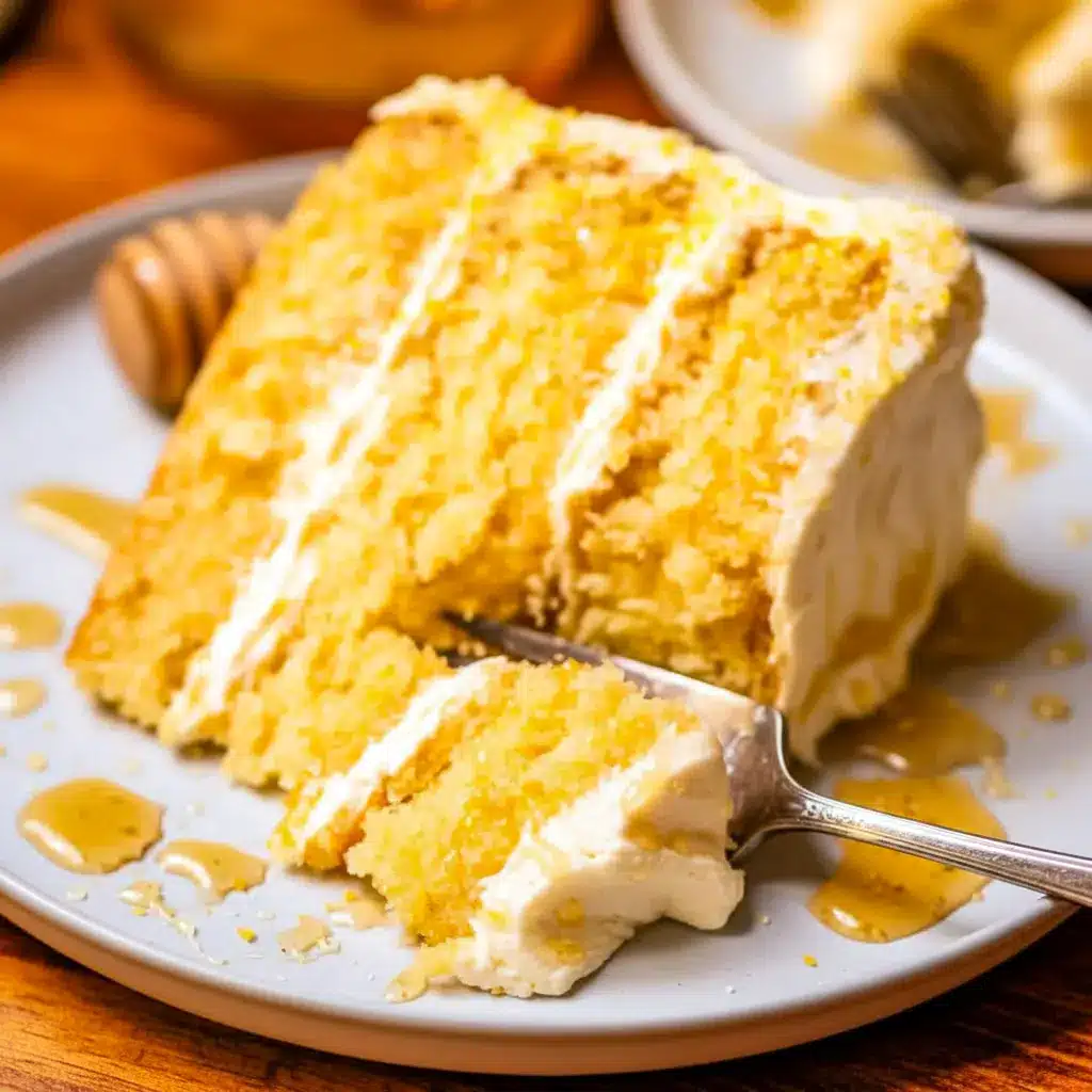 Close-up of a slice of Cornbread Cake layered with whipped honey buttercream, golden cornmeal crumb, and a honey drizzle — a rustic Cornbread Layer Cake that reads like a Cake Like Cornbread Recipe.