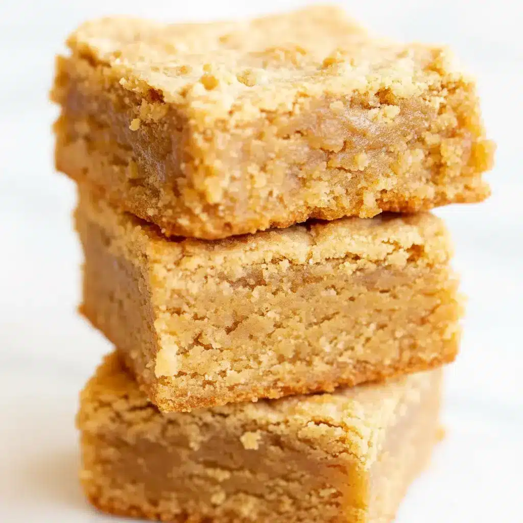 Close-up of a warm, crackly-topped Peanut Butter Brownies square with a melting scoop of vanilla ice cream beside it.