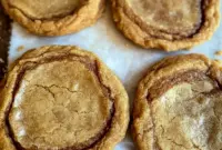Brown Butter Cinnamon Cookies stacked on a plate with golden edges and a soft center, showing a warm homemade treat perfect for Sweet Snacks and Christmas Baking.