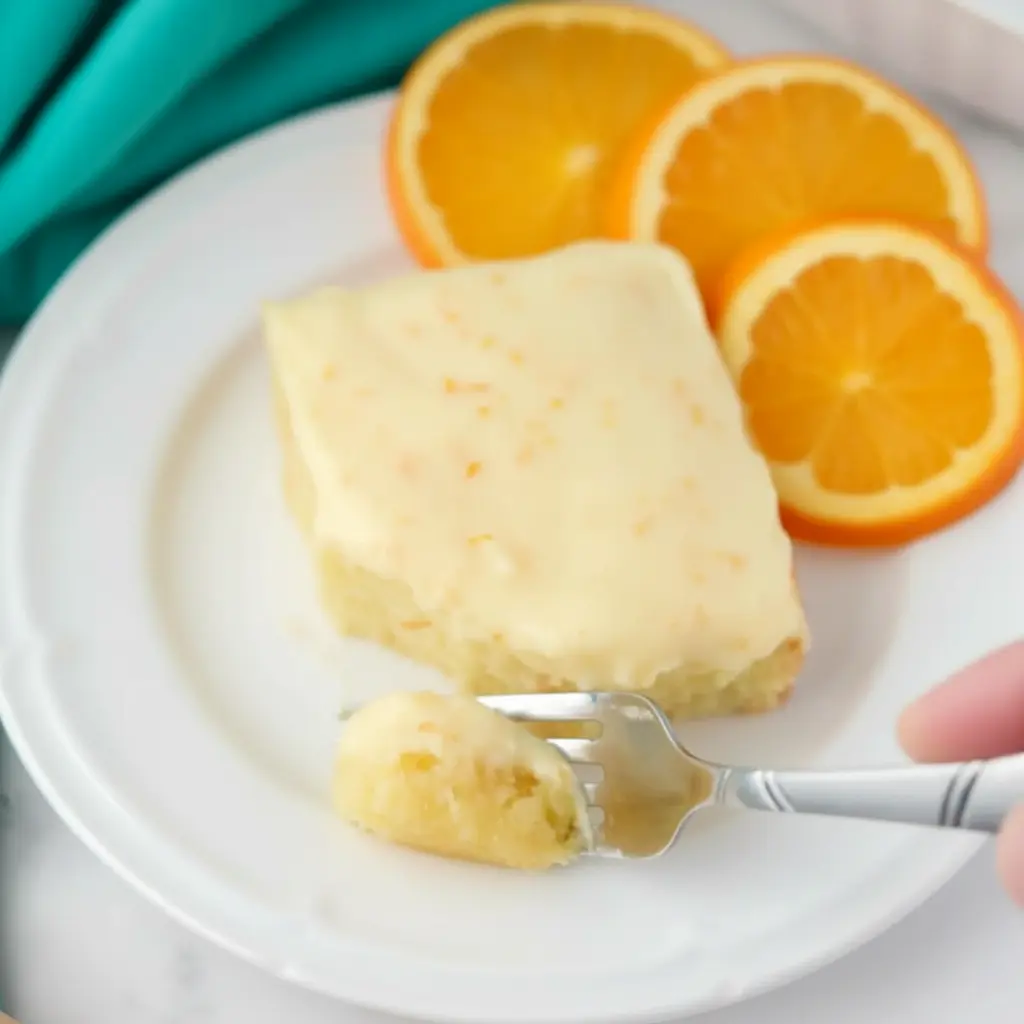 A pan of Orange Brownies cut into neat bars, a sunny dessert inspired by Desserts That Are Orange, Chocolate Orange Bars, Recipe Using Oranges, and Mandarin Orange Desserts.