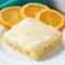 A square of Orange Brownies topped with creamy frosting, styled as one of the best Dessert Recipes With Orange Juice for a bright citrus treat.