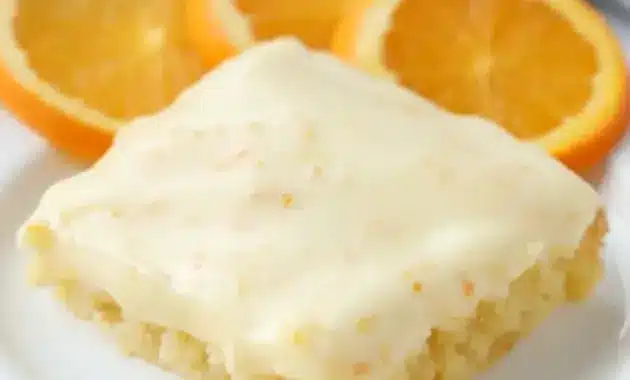 A square of Orange Brownies topped with creamy frosting, styled as one of the best Dessert Recipes With Orange Juice for a bright citrus treat.