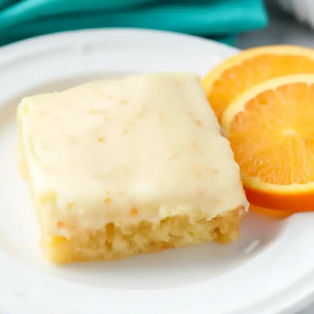 A square of Orange Brownies topped with creamy frosting, styled as one of the best Dessert Recipes With Orange Juice for a bright citrus treat.