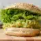 Smashed Chickpea Avocado Dill Pickle Sandwiches on whole grain bread with crisp lettuce and Avocado Chickpea Salad Sandwich filling for an easy healthy lunch.
