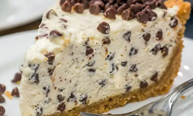 A creamy slice of Chocolate Chip Cannoli Pie with a smooth Cannoli Pie With Mascarpone filling and chocolate chips on top.